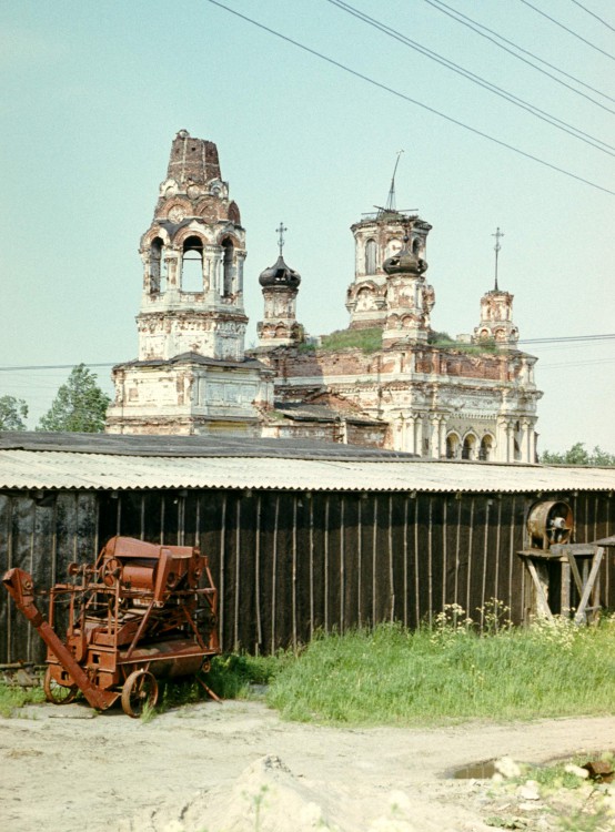 Низино. Церковь Александры Римской на Бабигонских высотах. фасады, На фоне бездействующей сельхозтехники