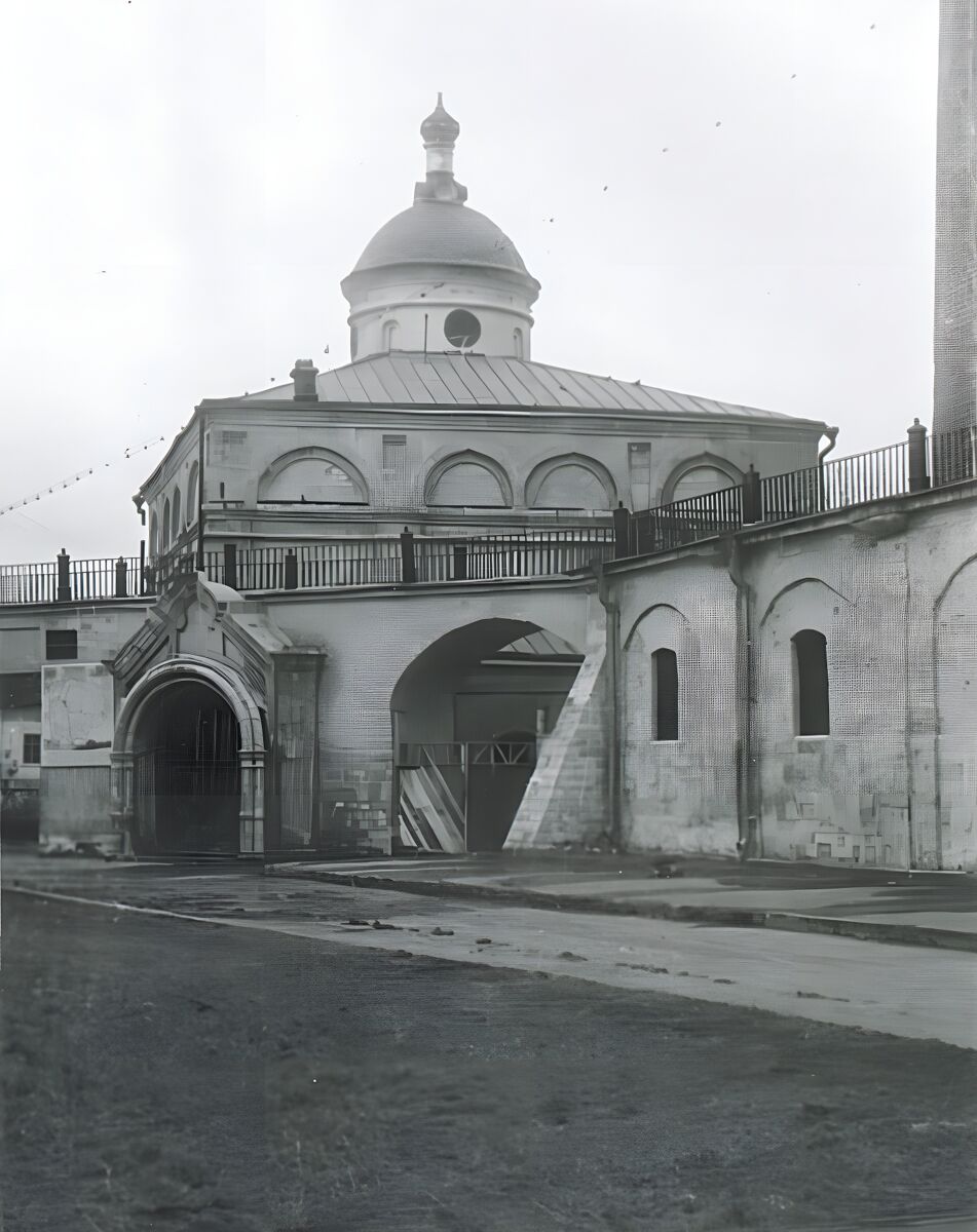 Собор Михаила Архангела, Рязань (Рязань, город, Рязанская область). архивная фотография, На снимке видна верхняя часть западного фасада и белокаменный портал пристроенной в ХIХ в. пониженной трапезной собора. Из окна трапезной выведена металлическая печная труба. Слева от входа в собор помещена вывеска музея, под ней карта-схема Рязанской области. Справа северная стена Успенского собора с гульбищем и переход к Дворцу Олега. В правой арке перехода деревянные ворота, в центральном проеме виден памятник Сталину, установленный в музейном дворе. Вокруг Успенского собора заасфальтированная отмостка, асфальтовая дорожка ведет к Христорождественскому собору.