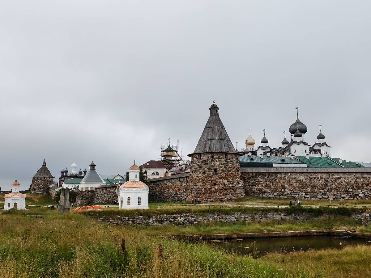 Отреставрированная часовня на фоне ансамбля Спасо-Преображенского монастыря, общий вид в ландшафте. Спасо-Преображенский Соловецкий монастырь. Часовня Петра и Павла, Соловецкий (Соловецкий район, Архангельская область)