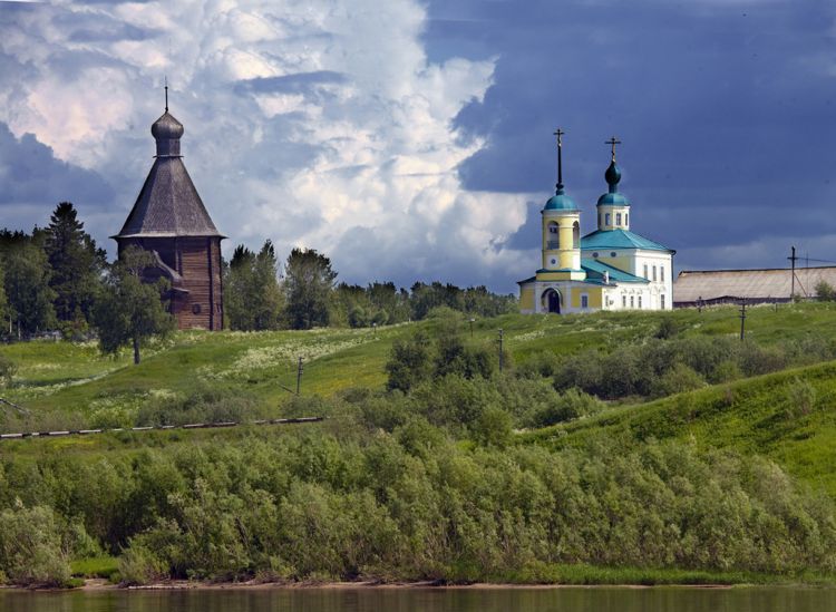 Новинки (Лявля). Храмовый комплекс. Церкви Николая Чудотворца и Успения Пресвятой Богородицы. фасады, Слева - деревянная Никольская церковь 1584 г.