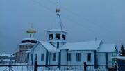 Церковь Успения Пресвятой Богородицы (новая), На заднем плане храм Преображения Господне в селе Ижма. Фотография 2018г<br>, Ижма, Ижемский район, Республика Коми