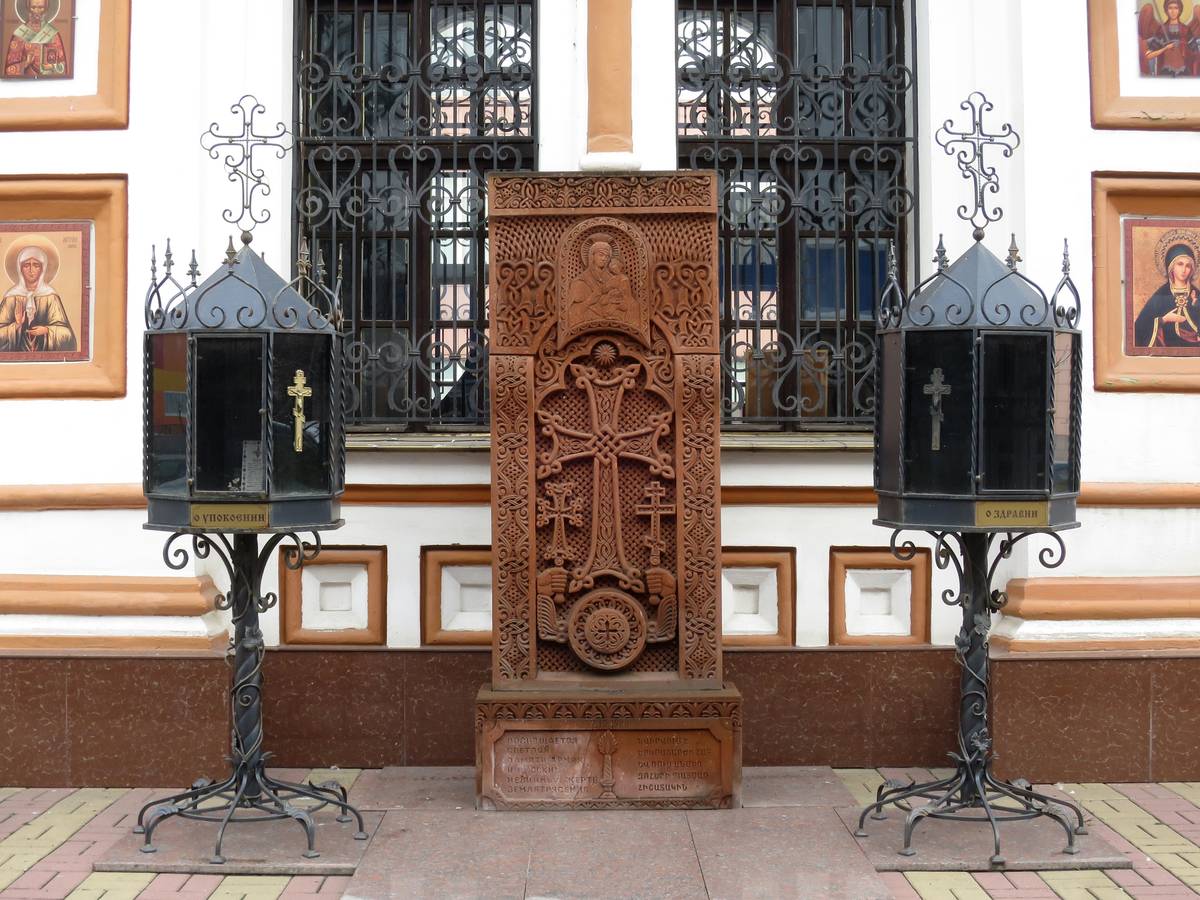 Хачкар у южной стороны часовни. Надпись на постаменте на русском и армянском языках: 